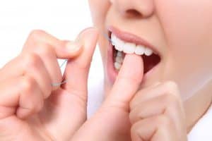 Female flossing her teeth