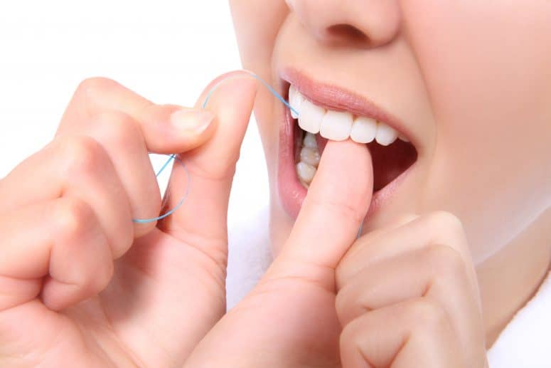 Flossing Is Important Female flossing her teeth