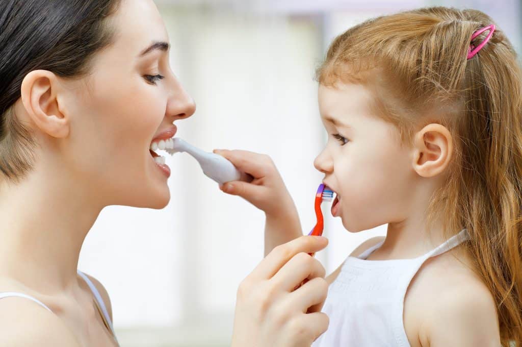 Brushing your teeth mother and daughter brush my teeth