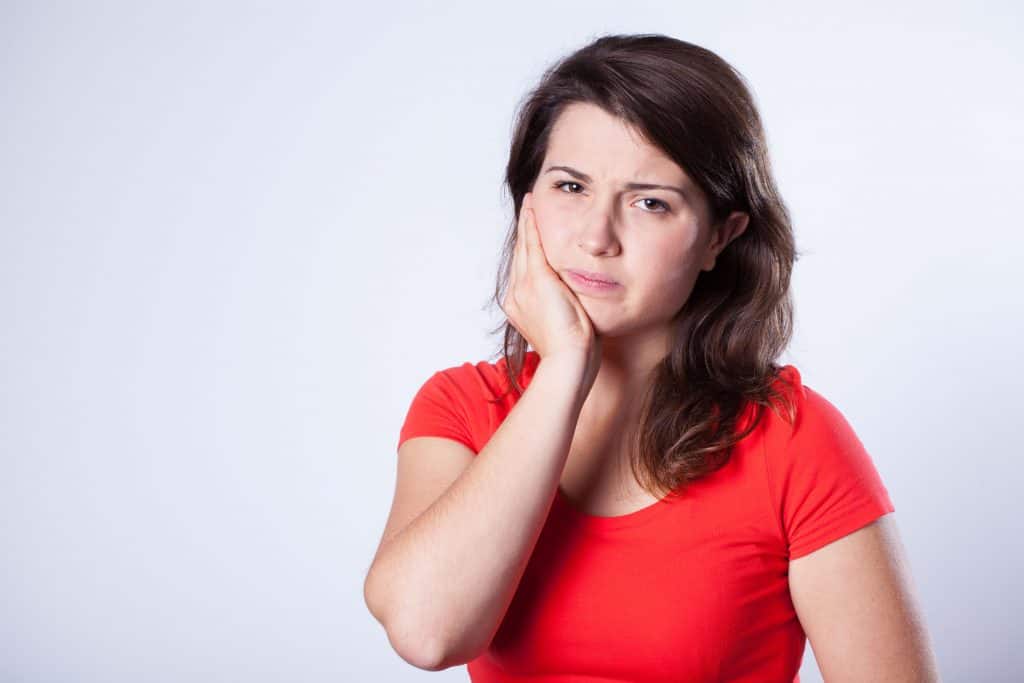 Young pretty girl with horrible pain in mandible