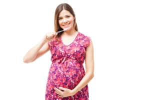 Pregnant woman taking care of her teeth