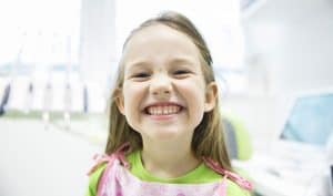 young girl smiling at the dentist