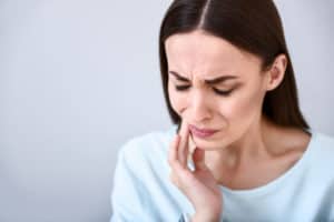 woman with jaw and tooth pain