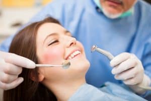 Dentist doing a dental treatment on a female patient