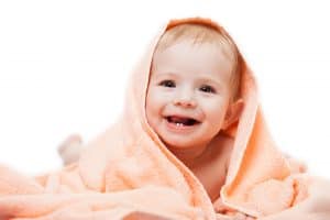 a baby happy with good dental health after breastfeeding