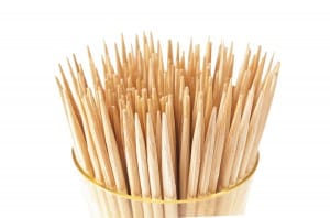 A lot of toothpicks in the cup. On a white background.