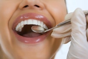 Close-up Of Female Patient Having Her Teeth Examined By Dentist Eagle Rock Dental Care