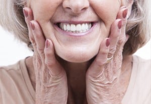 Senior woman with dentures after having them repaired