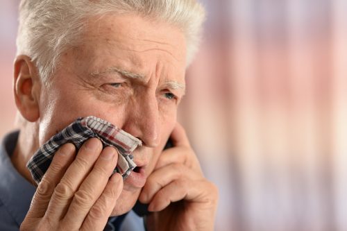 man with toothache calling emergency dentist