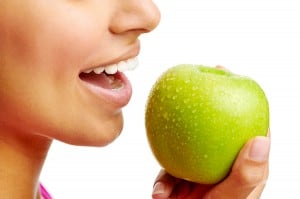 woman eating apple healthy diet and strong teeth