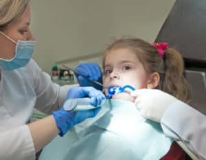 young girl receiving dental sealant