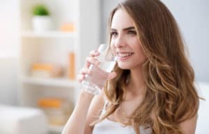 woman drinking a glass of water