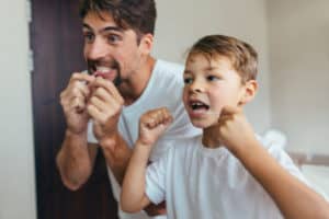 father and son flossing