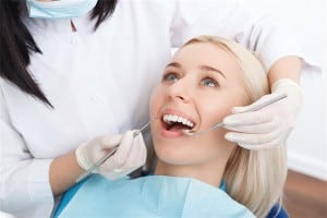 Woman having her teeth examined by dentist