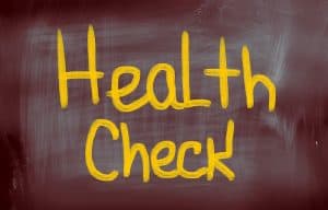 A chalk board with the words "health check" written on it for diabetes and gum disease awareness