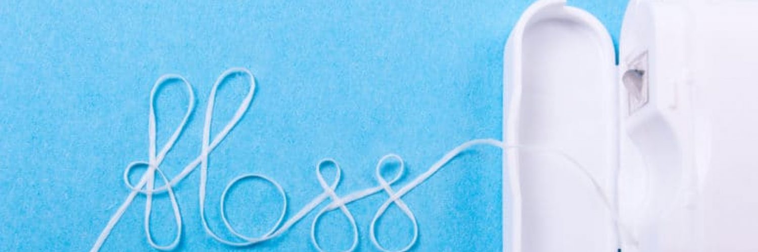 Dental floss word written in letters of floss on a blue background