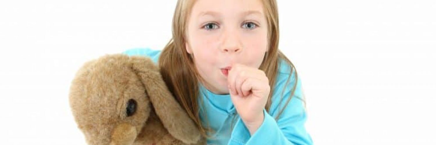 young girl holding her stuffed animal and sucking her thumb on white background