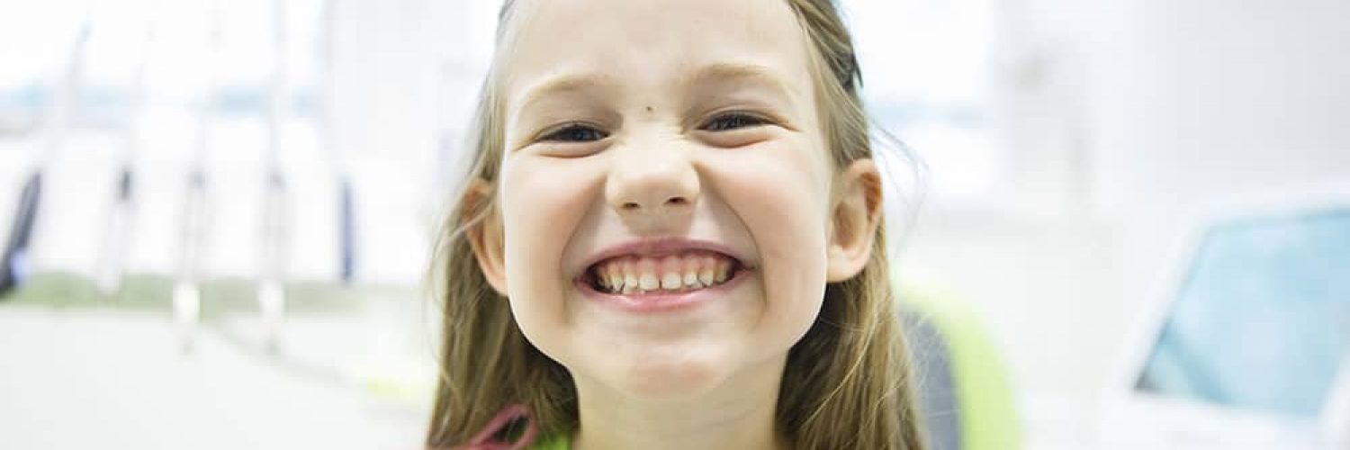 young girl smiling at the dentist