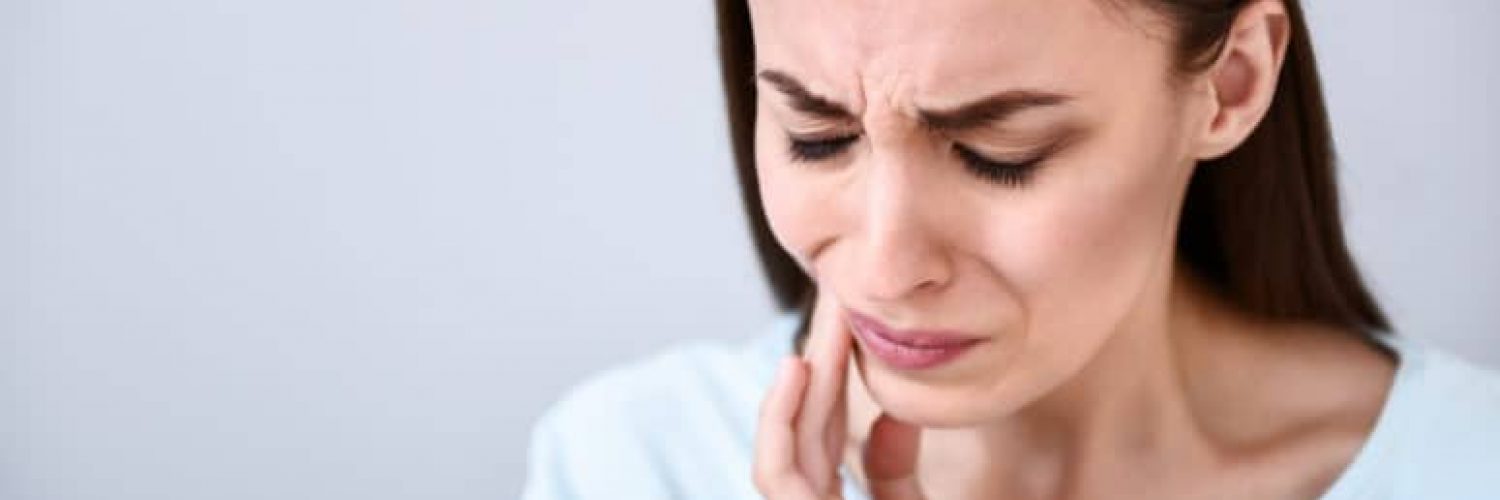 woman with jaw and tooth pain
