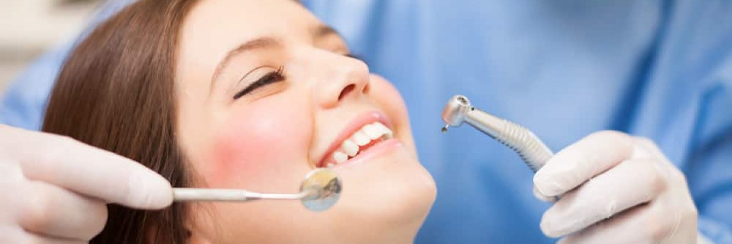 Dentist doing a dental treatment on a female patient