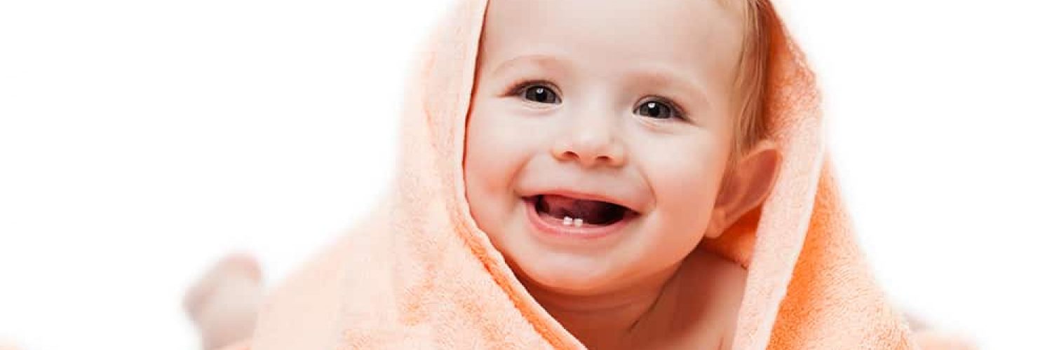 a baby happy with good dental health after breastfeeding