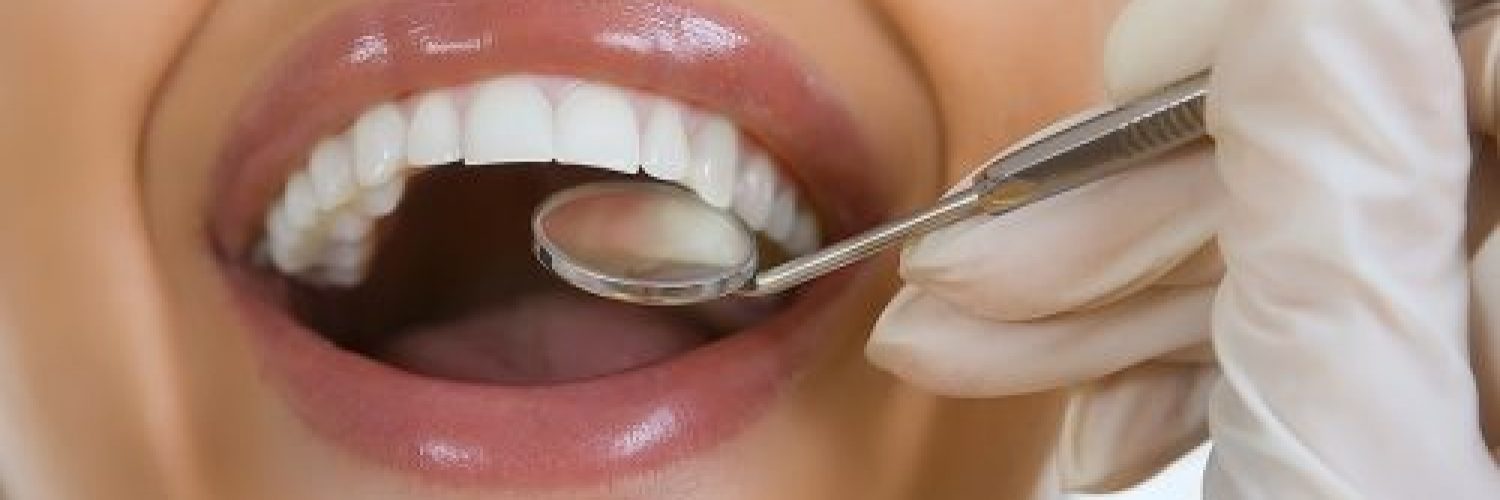 Close-up Of Female Patient Having Her Teeth Examined By Dentist Eagle Rock Dental Care