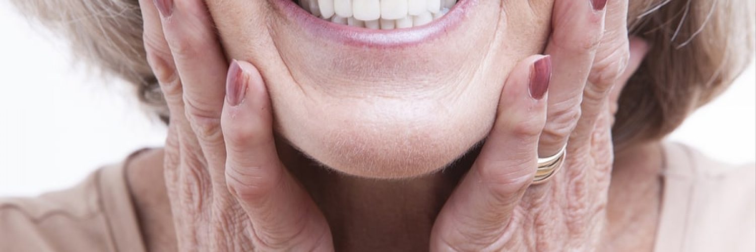 Senior woman with dentures after having them repaired