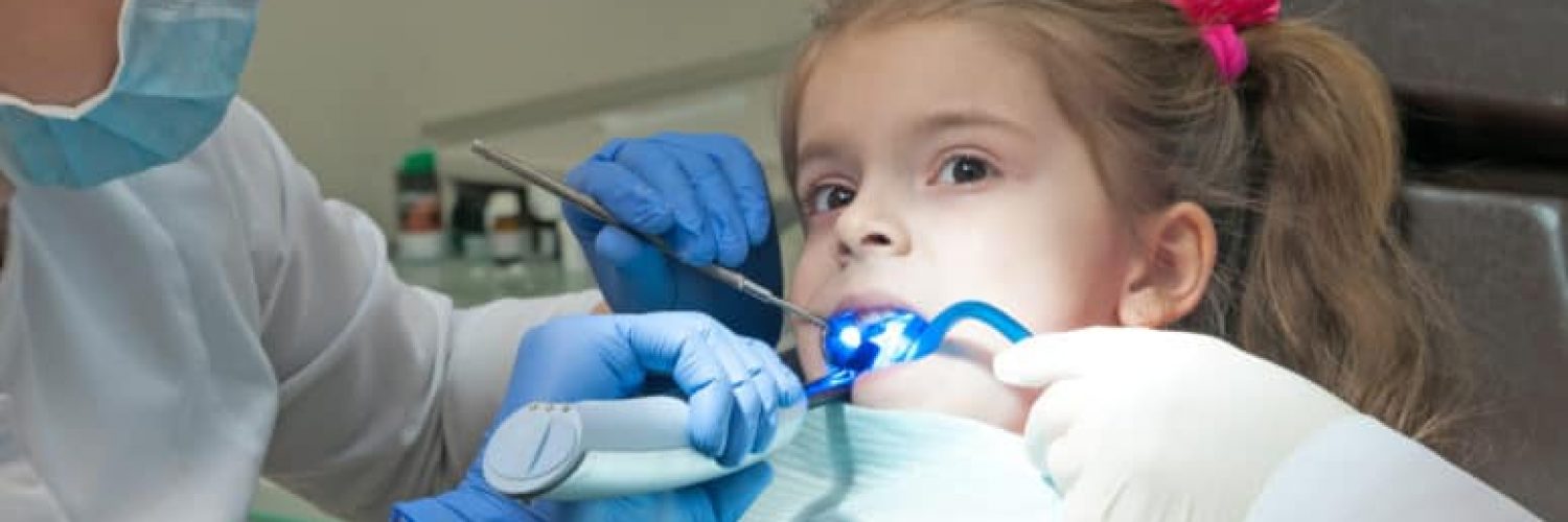 young girl receiving dental sealant
