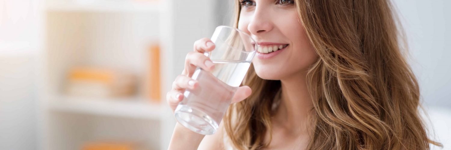 woman drinking a glass of water