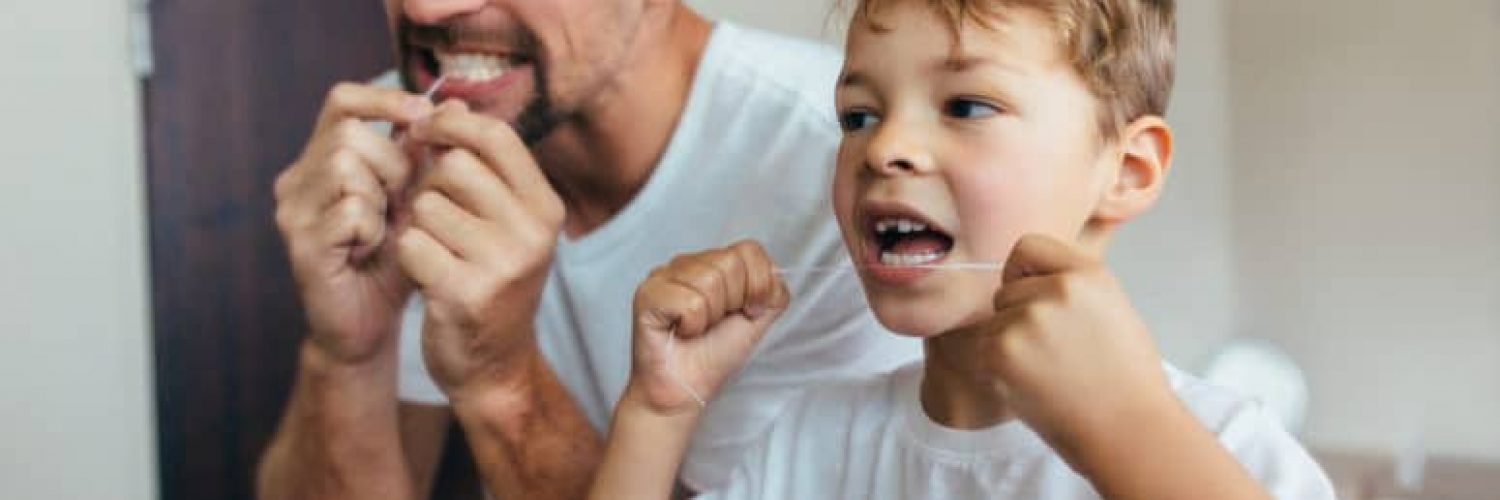 father and son flossing