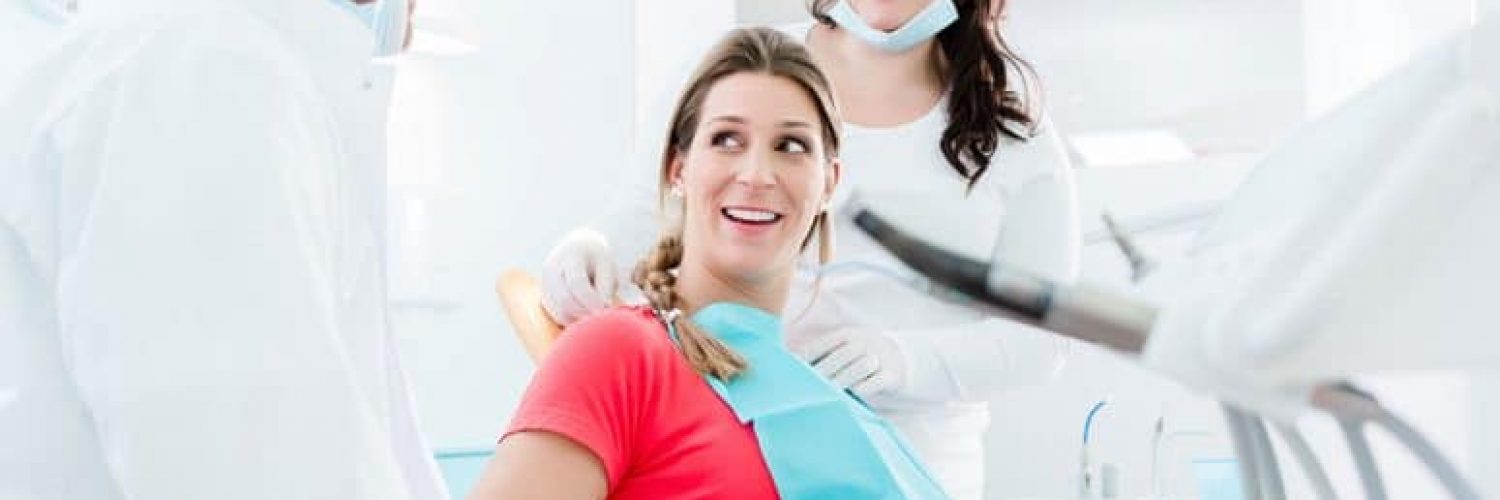 pregnant woman speaking with her dentist about pregnancy gingivitis