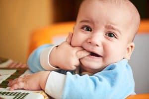 An infant teething in pain