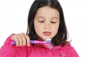 little cute girl brushing the teeth